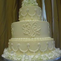 Wedding Jewelry Cake 3 tiers of yellow cake with raspberyy filling and IMBC icing. The top and bottom tiers are decorated to look like the jewelry the bride...