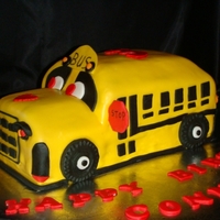 School Bus Cake Carved, chocolate, fondant covered cake with fondant/gumpaste accents.