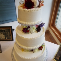 Daughter's Wedding Cake My first cake for an event was this wedding cake for my daughter. 3 tiered, multi-flavor, Zambito frosting, simple piping and real flowers...