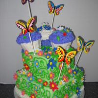 Butterfly Garden Four layer Chocolate cake with buttercream icing. Butterflies are hand painted fondant. vines and leaves are buttercream. Flowers are...