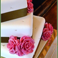 Green And Pink Offset Wedding Cake Green Ribbon, Pink Roses on rotated bases with diamantes