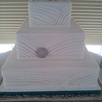 Fabric Inspired White Cake The bride had a beautiful sweetheart neckline that was pleated, so we tried to replicate that on the cake. I think it turned out nice!