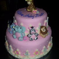 Kim's Shower 8" and 12" carrot cakes with cream cheese filling, covered in fondant with buttercream piping, fondant flowers and Sculpted...