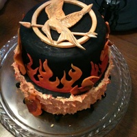 Hunger Games Inspired Birthday Cake The Pin Is Gum Paste Flames Are Fondant And Buttercream Hunger Games inspired birthday cake. The pin is gum paste. Flames are fondant and buttercream.
