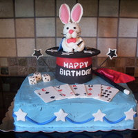 Magic Show Birthday Cake 2 layer, 11x15 inch cake base, topped with a rice krispy treat top hat and rabbit covered in fondant; with gumpaste playing cards, dice and...