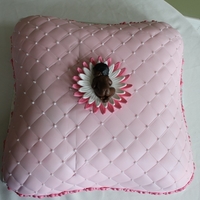 Baby Shower Pillow Cake Gumpaste baby in petal bed on a diamond pattern pillow.