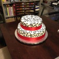 Red And Black Wedding Cake. Front of cake - White MMF with red ribbon and black chocolate buttercream detail.