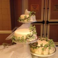 Mid Summer Nights Dream Wedding Cake. All cakes are different flavours - Covered with a champagne coloured MMF. Decorated with gumpaste ivy leaves.