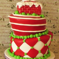 The Big Man's Coming To Town 8" & 9" Carved Topsy Turvy. Chimney and legs are fondant covered RKT. Edible glitter on the "snow"