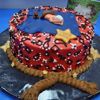 Baby Cowboy Fudge cake with cream cheese icing. The accents are 50/50 gumpaste fondant.Baby is from a mold with details added.
