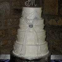 Shimmer And Bling This cake was an 8", 10", 12" and 14" done in buttercream with fondant accents. It was airbrushed with pearl shimmer.