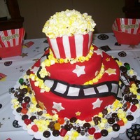 Movie Themed Cake I made this for my husbands 30th birthday. The popcorn is made out of mini marshmallows which I cut and painted yellow with food coloring...