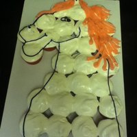 Cupcake Cake/horse client wanted white horse with pink hair. Are cupcakes with whipped dairy icing.