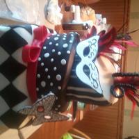 Sweet 16 Masquerade Ball Cake Black and white with a splash of red, slightly topsey turvy, Masquerade Ball theme cake for Sweet 16! Masks are gumpaste and cake is...