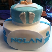 2 Tier Baby Boy Cake 2 tier baby cake. Buttercream icing with fondant accents