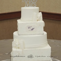 Alternating Square And Round Wedding Cake Buttercream frosted cake with fondant bows. I am very pleased with how this one turned out! Classic with a hint of modern. Love it!!!