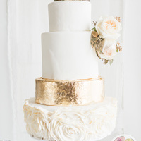 Gold Leaf Wedding Cake Edible gold leaf wedding cake with fondant ruffle roses. Ruffle roses are bushed with gold as well.