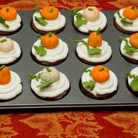 Pumpkin Cupcakes Pumpkin cupcakes with fondant mini pumpkins, vines and leaves. Ready to snap the lid on and take to work.