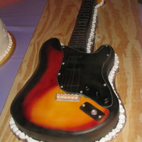 Fender This was a grooms cake for a musician, it was a copy of his guitar and the exact size of it. I traced his guitar and carved the cake from...