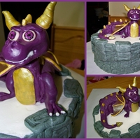 Skylander Spyro Cake 10" round with purple dragon. Body of dragon is cake, covered in candy clay... head, tail, legs, wings are candy clay.