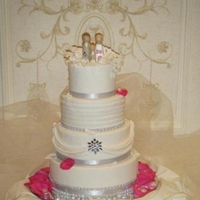 White Wedding With Bling Fashoned after the brides dress, 4 layered dummy cake with real cake cut out. Fondant covered dummies