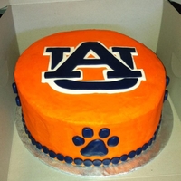 Auburn Tigers Orange Cream cheese with Navy blue fondant shapped into paw prints and I made a template for the AU sign and just cut it out.