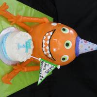Three Eyed Monster With Smash Cake This was a 1st birthday cake for a little boy. The three eyed monster was carved and covered with fondant. The little cake in front of the...