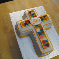 1St Communion Standard cross cake out of buttercream. For the stained-glass effect I broke up lollipops and arranged them onto a cookie sheet in a cross...