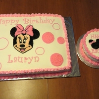 Minnie Mouse 1St Birthday Big cake is made out of buttercream icing with fondant letters. Smash cake has fondant bow and fondant 1's on sides.