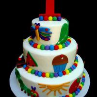 The Very Hungry Caterpillar This is a 6"9"12" round. Each tier is 3" high and covered in buttercream icing. The accent pieces are made of fondant...