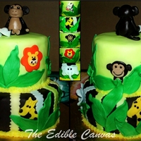 Jungle Themed Baby Shower Cake 8" and 6" Vanilla and Strawberry cake. Buttercream and Colored & Chocolate Fondant. Hand made fondant animals & blue baby...