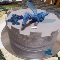 Dragon Cake Dragon cake for my nephew. Dragon is gumpaste with gelatin wings and isomalt stash of gems, chomping down on a bone sticking out of his...