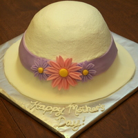 Hat Cake For Mother's Day What's more mother than a simple, spring like hat? Rounded cake with a fondant/gumpaste mixture brim and colored daisies.