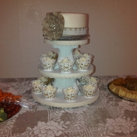 Allison's Shower Yellow cupcakes and cake with cream cheese icing with burlap ribbon and flower with lace.