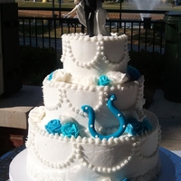Colts Wedding Cake Full buttercream cake including buttercream roses and a handmade Colts horseshoe. Topper by couple