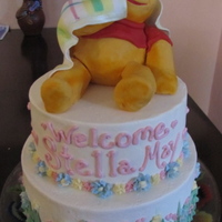 Pooh Bear Baby Shower two tiered lemon cake with Pooh made out of rice treats and fondant. The blankie was a replica of the brides original one.