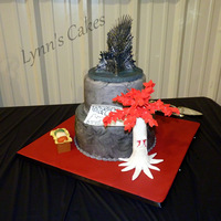 Game Of Thrones Grooms Cake Game of Thrones themed grooms cake. Buttercream iced cake with fondant accents. The Iron Throne topper is a resin figurine.