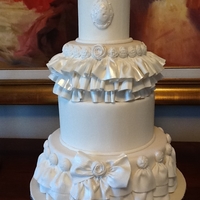 Ruffles And Bows 4-tier round wedding cake with gumpaste decorations
