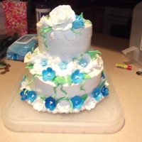 Wedding Cake My first wedding cake, fondant flowers and leaves. White cake with chocolate ganach filling and buttercream.