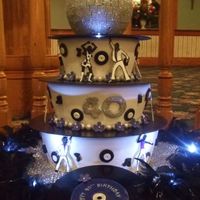 Disco Tiered cake with the records and dancers made of gum paste. We also added lights.