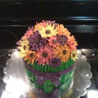 Bouquet Of Flowers 6 inch vanilla cake with chocolate ganache frosting and raspberry filling. Fondant accents