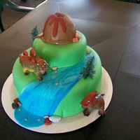 Dinosaur Cake frosted with butter cream, covered in MMF. volcano is a mini cake also. all MMF decorations except the dinosaurs. thanks for looking!