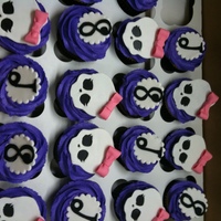 Monster High Cupcakes for 8th birthday with Monster High theme. I did not even know what that was. ha! Skulls made with fondant covered in pearl dust.