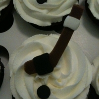 Hockey! Hockey stick/puck cupcakes for my nephew. Made from chocolate fondant. Simple, but the hockey team loved them!