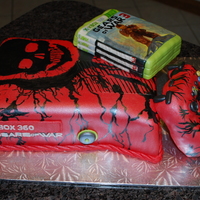 Gears Of War Groom's Cake Gears of War Groom's Cake. Cake covered in fondant with hand painted designs to look like this special edition XBOX console.
