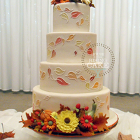 Autumn Wedding Cake Ivory fondant with hand painted and piped falling leaves and handmade sugar decorations. Vanilla cake with vanilla buttercream