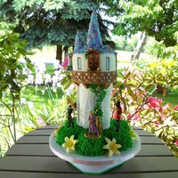 Tangled Tangled cake I made for my daughters 4th birthday. Flowers represent the magical flower from the movie. I dusted them with pearl dust to...