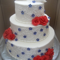 Buttercream Wedding Cake WASC cake, light raspberry mousse filling, vanilla buttercream. Flowers and birds are made out of fondant.