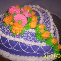 Purple Heart Puffed heart pan, Pink flowers made of Royal icing, Orange flowers made of BC icing. White cake mix with BC icing.