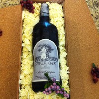 Silver Oak Birthday cake for my husbands BFF. Silver Oak lover. Not to bad for my first wine bottle cake but dissapointed that my fondant bottle didn...
